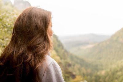 woman gazing at mountain scenery