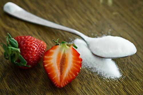 strawberries and a spoon full of sugar