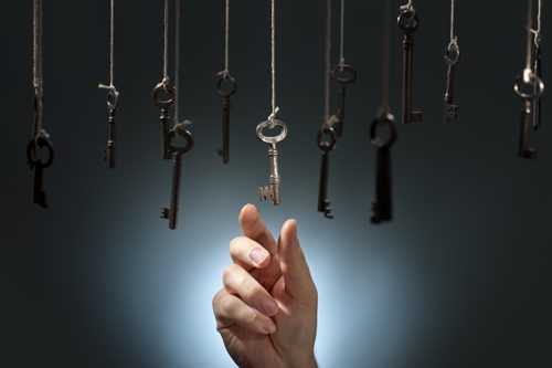 hand reaching for one key out of many keys - 12-step programs