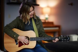 Creative Arts Therapy in Recovery, Arts Therapy in Recovery, Creative activities in recovery, young woman playing acoustic guitar at home - creative arts