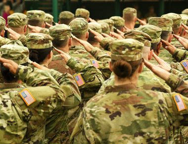 US soldiers standing in formation, saluting - veterans program