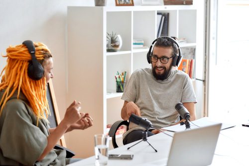 young man and young woman recording a podcast in an office or studio - recovery podcasts